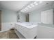 Bathroom featuring double vanity, mirrors, and paneled walls at 37 E 14Th Pl, Broomfield, CO 80020