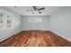 Cozy bedroom with wood floors, ceiling fan, and bright, shuttered windows at 37 E 14Th Pl, Broomfield, CO 80020