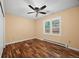 Bedroom featuring hardwood floors, tan walls, a ceiling fan, and a large window at 37 E 14Th Pl, Broomfield, CO 80020