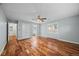 Large bedroom with wood floors, ceiling fan, ensuite bathroom, and hallway access at 37 E 14Th Pl, Broomfield, CO 80020