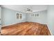 Spacious bedroom features hardwood floors, light blue walls, a ceiling fan, and large windows at 37 E 14Th Pl, Broomfield, CO 80020