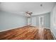 Open bedroom features hardwood floors, light blue walls, and entry ways to a walk in closet and bathroom at 37 E 14Th Pl, Broomfield, CO 80020