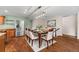 Dining area featuring a modern table set, wood floors, and stainless steel refrigerator at 37 E 14Th Pl, Broomfield, CO 80020