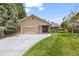 Charming exterior of a home with a lush green lawn and a driveway leading to an attached garage at 37 E 14Th Pl, Broomfield, CO 80020