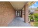 Inviting front porch with brick columns and hanging plants, providing a charming welcome to the home at 37 E 14Th Pl, Broomfield, CO 80020