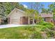 Well-maintained front yard with healthy grass, flowering plants, and a large tree at 37 E 14Th Pl, Broomfield, CO 80020