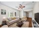 Bright living room with bay window, ceiling fan, and hardwood floors offers comfortable seating at 37 E 14Th Pl, Broomfield, CO 80020