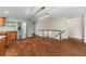 Open-concept space with living room, kitchen, and stairway featuring wood-look tile flooring throughout at 37 E 14Th Pl, Broomfield, CO 80020
