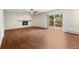 Large living room with tile floors, a fireplace, and a sliding door to a patio with a greenhouse at 37 E 14Th Pl, Broomfield, CO 80020
