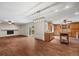 Spacious open-concept living room with wood-look tile flooring, fireplace, and sliding glass doors at 37 E 14Th Pl, Broomfield, CO 80020