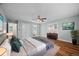 Spacious main bedroom with hardwood floors, a ceiling fan, and a large window with shutters at 37 E 14Th Pl, Broomfield, CO 80020