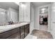 Elegant bathroom with double sinks, walk-in shower, and large closet at 533 Pioneer Ct, Fort Lupton, CO 80621