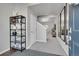 Bright entryway with hardwood floors, a metal shelf, and mirrors at 533 Pioneer Ct, Fort Lupton, CO 80621