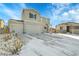 Two-story house with gray siding, attached garage, and snowy front yard at 533 Pioneer Ct, Fort Lupton, CO 80621