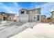 Two-story house with gray siding, attached garage, and snowy front yard at 533 Pioneer Ct, Fort Lupton, CO 80621