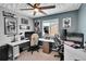 Modern home office with two work stations and ceiling fan at 533 Pioneer Ct, Fort Lupton, CO 80621