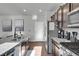 Modern kitchen with stainless steel appliances and granite countertops at 533 Pioneer Ct, Fort Lupton, CO 80621