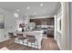 Modern kitchen with dark cabinets, granite countertops, and island at 533 Pioneer Ct, Fort Lupton, CO 80621