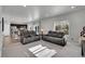 Spacious living room with gray couches and view into kitchen at 533 Pioneer Ct, Fort Lupton, CO 80621