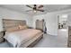 Main bedroom with king bed, ceiling fan and view into office at 533 Pioneer Ct, Fort Lupton, CO 80621