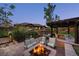 Spacious backyard with an outdoor kitchen, fire pit, patio seating, and beautiful views of the home at 722 Evening Star Dr, Castle Rock, CO 80108