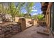 Beautiful backyard featuring multiple levels, stone retaining walls, lush greenery, and outdoor seating at 722 Evening Star Dr, Castle Rock, CO 80108