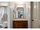 Bathroom featuring a vanity with sink and a shower-tub combo with glass doors at 722 Evening Star Dr, Castle Rock, CO 80108