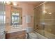 Bright bathroom featuring a vanity with sink and a shower-tub combo with glass doors at 722 Evening Star Dr, Castle Rock, CO 80108