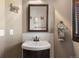 Charming bathroom features a pedestal sink, framed mirror, and rustic accents at 722 Evening Star Dr, Castle Rock, CO 80108