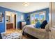 Cozy bedroom with a large window offering picturesque views and en suite bathroom at 722 Evening Star Dr, Castle Rock, CO 80108