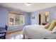 Bedroom with a large window offering views and an adjacent bathroom at 722 Evening Star Dr, Castle Rock, CO 80108