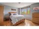 Cozy bedroom with hardwood floors, natural light, and comfortable decor at 722 Evening Star Dr, Castle Rock, CO 80108