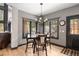 Cozy dining area with natural light, elegant chandelier, and views of lush landscaping at 722 Evening Star Dr, Castle Rock, CO 80108