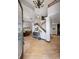 Bright and welcoming foyer featuring gleaming wood floors, soaring ceilings, and a wooden staircase at 722 Evening Star Dr, Castle Rock, CO 80108