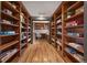 A hallway lined with custom wood bookshelves leads to a private office space at 722 Evening Star Dr, Castle Rock, CO 80108