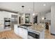 Stylish kitchen island featuring a gas range, granite countertops, stainless steel appliances, and lighting at 722 Evening Star Dr, Castle Rock, CO 80108
