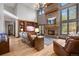 Comfortable living room showcasing a stone fireplace, hardwood floors, and large windows at 722 Evening Star Dr, Castle Rock, CO 80108