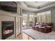 Cozy living room with a fireplace, plush rug, and a comfortable sofa at 722 Evening Star Dr, Castle Rock, CO 80108