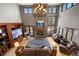 Open-concept living room with soaring ceilings, a stone fireplace, a TV, and large windows at 722 Evening Star Dr, Castle Rock, CO 80108
