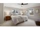 Cozy bedroom with neutral tones, two windows and plush bedding creates a relaxing atmosphere at 6341 E Floyd Dr, Denver, CO 80222