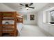 Bedroom with bunk beds features a ceiling fan, built-in window seat and a decorative bear picture at 6341 E Floyd Dr, Denver, CO 80222