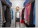 Walk-in closet provides ample storage with shelves, hanging rods, and view to bathroom at 6341 E Floyd Dr, Denver, CO 80222