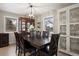 Dining room with a large wooden table and chairs, china cabinet, and natural light at 6341 E Floyd Dr, Denver, CO 80222