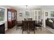 Dining area with a large wooden table, seating for six, and natural light from multiple windows at 6341 E Floyd Dr, Denver, CO 80222