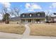 Inviting home featuring a well-manicured lawn, charming front porch, and classic architectural details at 6341 E Floyd Dr, Denver, CO 80222