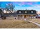 Charming home featuring a cozy front porch with seating and a well-manicured front lawn at 6341 E Floyd Dr, Denver, CO 80222