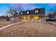 Inviting two-story home featuring a covered porch with seating and a well-maintained front lawn at 6341 E Floyd Dr, Denver, CO 80222