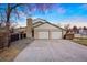 Home's exterior showcasing a convenient two-car garage and well-kept front yard with mature trees at 6341 E Floyd Dr, Denver, CO 80222