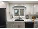 Well-lit kitchen features bright white cabinets and drawers, wood floors, and stainless steel appliances at 6341 E Floyd Dr, Denver, CO 80222