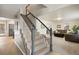 Inviting staircase with natural wood steps and grey accents leads to the upper level of the house at 6341 E Floyd Dr, Denver, CO 80222